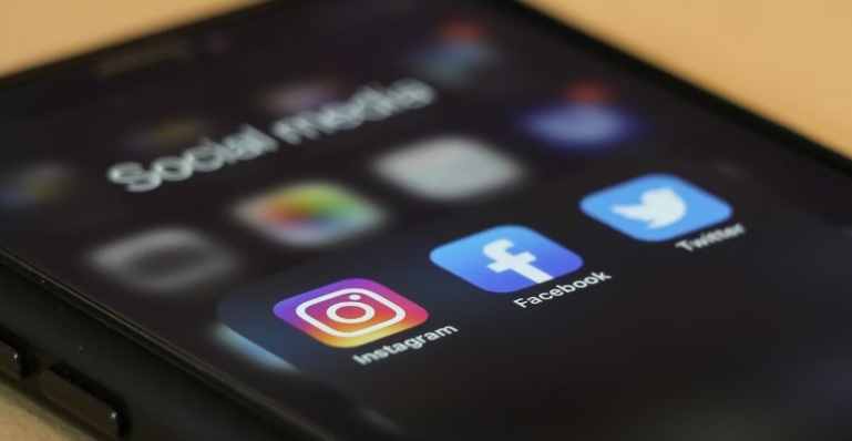 Phone with Instagram, Facebook, and Twitter social media apps.